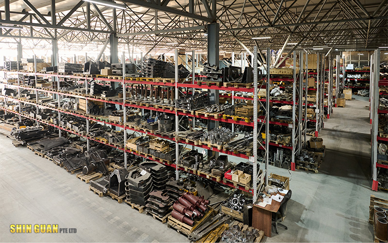 Large industrial warehouse with organised metal parts and components stored on multi-level racks